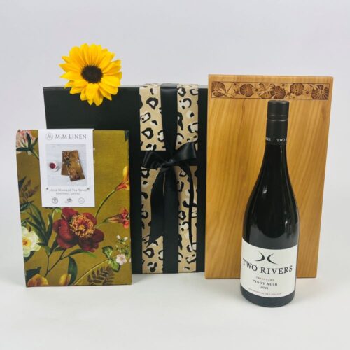 The Welcome Home Gift Hamper is the perfect practical gift. With a gorgeous Macrocarpa bread board, a stunning MM Linen Tea Towel and a bottle of Two Rivers Pinot Noir. The perfect housewarming gift. Gift Baskets NZ. Gifts for You & Me.