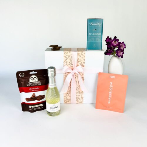 The Effervescent Delight Gift Basket includes a bottle of Freixenet Prosecco, a bag of Potter Brothers chocolates, face mask and Bennetts of Mangawhai chocolate. The perfect Luxury gift box for her. Gifts for You & Me.