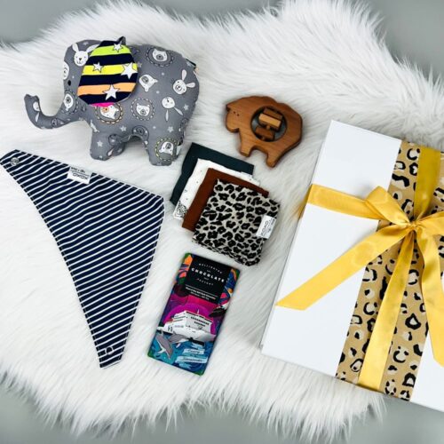 The Precious Baby Neutral Gift Basket is the perfect gift box for babies. Contained in the luxury gift box is a handmade one of a kind elephant soft toy, a handmade bib and wash cloths, sheep rattle and a bar of Wellington Chocolate Factory chocolate. Gift Boxes NZ. Gifts for You & Me.