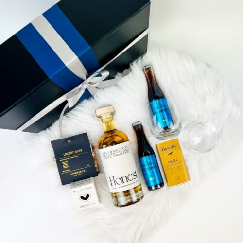 The Honest to Goodness Rum Gift Hamper is perfect for any Rum lover. Includes a bottle of Honest spiced rum, two glasses, two bottles of Cola, a brownie, nuts & chocolate. Gifts for You & Me