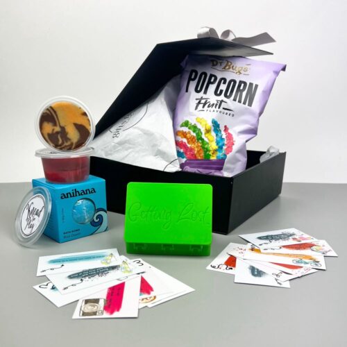 Included in the kids adventure box is a game of "getting lost", a bath bomb, fruit popcorn and two pots of scented playdough. A fun gift box for kids. Gifts for You & Me. Gift packs for kids.