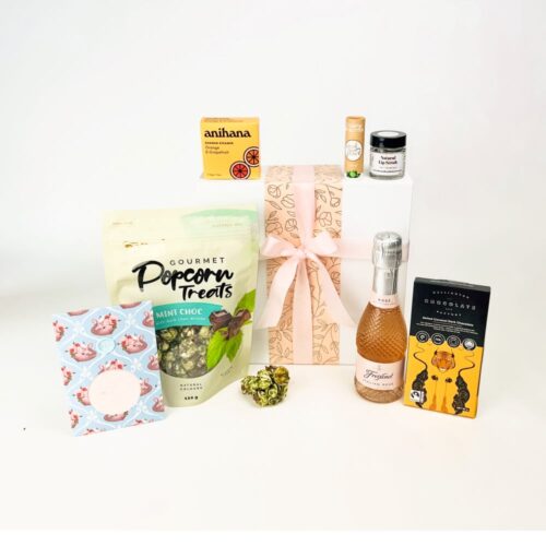 The Summer Fizz & Bubbles Gift Basket contains a bottle of sparkling Freixenet Italian Rose, a clay mask, mint chocolate popcorn, lip scrub, lip balm, a shower steamer and a bar of Wellington Chocolate Factory chocolate. Gifts boxes for her. Gifts for You & Me