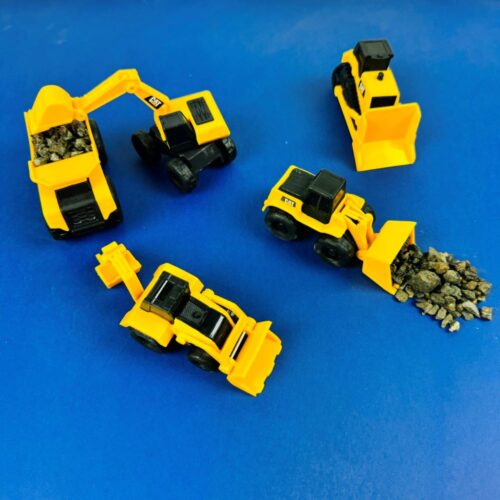 Construction toys. Gifts for Kids. Image of toys in play; including dump truck, excavator, loader, bulldozer and back hoe. Perfect for any machine mad child